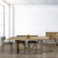 Dining room with wooden table and chairs against a white brick wall.